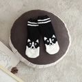 Plush coral fleece socks in black and white featuring a cute cartoon husky pattern - One Size / Black