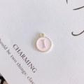 Detail of pink enamel round pendant with gold letter I for DIY jewelry making - Letter I