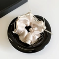 Beige silk satin scrunchie with small bow detail in a black glossy bowl - Khaki