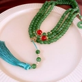Macro detail of dark green beaded necklace with gold carvings and a blue tassel - 10# Necklace-Dark Green Buddhist Beads Tassel-8mm