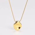 Macro shot of 18K gold irregular pebble pendant with polished mirror finish snake chain - Gold