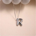 Macro view of silver balloon-style letter R pendant with metallic fold textures - Silver (With Necklace) R