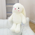 Close-up of a white plush rabbit toy with pink embroidery details sitting on a sofa - 40CM / White