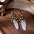 Detail of bohemian long feather earrings with white beads on a rustic wooden tray - Antique Bronze and White Feather Style(E2177-1)