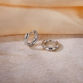 Minimalist silver circular hoop earrings in pairs on a beige stone and orange base - Inner Diameter 8mm / Steel