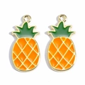 Detail showing two gold-tone pineapple charms with orange enamel and green leaves - Pineapple