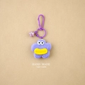Detail of purple star plush keychain with yellow lips and pink translucent charm - Light Purple