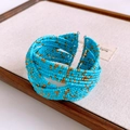 Detail of bohemian wide open cuff bracelet with blue and gold woven bead patterns - Gold Blue Bead Woven Cuff (29#)