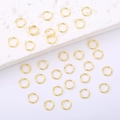 Set of 14K gold plated open jump rings for DIY jewelry making on white marble - Width 4mm / 18K Gold Plated
