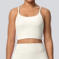 Close-up of cream yoga top featuring thin shoulder straps and high-elastic ribbed fabric - S / Tops / Light Ivory