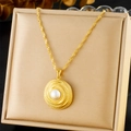 Golden necklace with circular texture and pearl pendant in a beige jewelry box - Necklace (N3153)