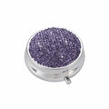 Top view of circular silver pill box with purple rhinestone lid on white background - Lotus Purple