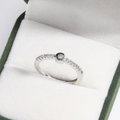 Macro shot of silver adjustable letter ring with diamonds in a green jewelry gift box - White & Gold Style C