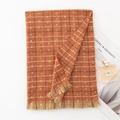 Orange plaid knit scarf with white dots and fringe edges laid out with props - 65*190cm / Orange