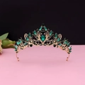 Detail of vintage gold crown featuring emerald green crystals and ornate leaf patterns - No.2 KC Gold (Green Stone)