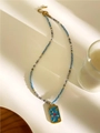 Detail of beaded necklace featuring blue enamel square pendant with a red heart element - Blue Square Plate