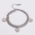 Detailed close-up of a double-layer stainless steel bracelet with three crystal heart charms - Steel