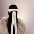Elegant white satin ribbon bow hair clip worn by a model for a graceful hairstyle - Small Hair Accessory / Beige