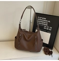 Detailed close-up of brown lychee-patterned PU leather tote with vertical zip pockets - Brown