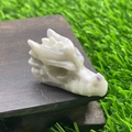 Hand-carved white and purple natural stone dragon head on a wooden display base - Auspicious Jade