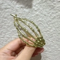 Gothic gold metal skeleton hand hair claw clip held in hand against a neutral wall - 22# Gold Skeleton Hand Twist Clip