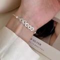 Elegant silver chain bracelet with coin ring charms and pearl clasp on female wrist - Silver Coin Ring Pearl Buckle (MY37098)