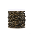 Detail of DIY jewelry chain with black beads on a white spool for craft making - Black