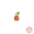 Macro detail of apple ear stud crafted from S925 silver with orange and green gems - Orange
