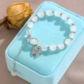 Moonstone style beaded bracelet with sparkling butterfly pendant on blue velvet - Butterfly and Moonstone Style / White K (K-332)