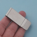 Minimalist brushed stainless steel money clip held in hand against blue background - Brushed Steel Money Clip