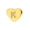 Macro shot of gold-plated heart bead featuring an embossed letter K with polished finish - Letter K
