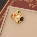 Macro shot of gold hammer-textured ring with pearl and colorful gemstone details - 6# Black Ring