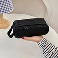 Detail showing the black double-layer nylon pouch with metal zipper and handle strap - Black