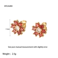 Detailed view of flower-shaped stud earrings with red and white zircons in 11mm size - Red
