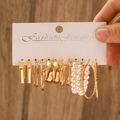 Golden geometric earring set with faux pearls on display card over wooden surface - KC Gold (H-55)