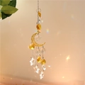 Golden crescent moon wind chime with crystal stars and suncatchers creating rainbow light - Gold Moon