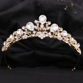 Close-up of golden bridal tiara with intricate leaf design and sparkling waterdrop crystals - KC Gold White Rhinestone