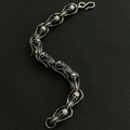 Detail of silver skull and cobra dragon bone bracelet with S-hook on dark background - Cobra Skull 21cm