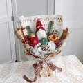 Christmas bouquet with plush gnome, reindeer, pine cones, and berries in kraft paper - Yellow