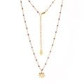 Detail of gold stainless steel necklace featuring purple beads and a small flower pendant - Purple