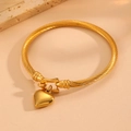 Titanium steel cable bracelet with gold heart pendant shown at a 45-degree angle - Heart Twisted Cable Bracelet (S107) / Gold