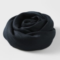 Solid dark blue cotton linen scarf styled in a decorative rose shape on white background - Navy Blue