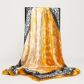 Detailed view of yellow and white paisley silk scarf with neatly rolled edges and soft texture - 90*90cm / Yellow