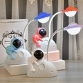 Cartoon astronaut LED desk lamps shown in blue, pink, orange, and purple color variants - Moon Astronaut Desk Lamp (6617-1)