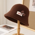 Detailed view of the dark brown wool bucket hat with white polka dot bow and woven label - M (56-58cm) / Bow Label Style / Brown