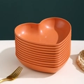 Stack of elegant orange heart-shaped plastic fruit plates with golden rim detail - Sunset Orange-Heart Dish