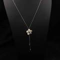 Golden necklace featuring flower pendant with mother of pearl and blue gemstone accents - Lapis Lazuli Flower Pendant Style