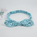 Blue paisley print knot headband with bunny ears and elastic band on white background - Green Paisley