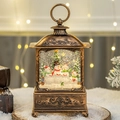 Bronze Christmas lantern snow globe with snowmen and festive glitter accents - Snowman Family of Four