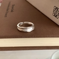 Macro detail of S925 sterling silver wavy open ring showing the hallmark and metal texture - S925 Silver Textured (JZ0826)